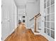 Hallway featuring hardwood floors with staircase and doorway views of the living area at 207 Cole Ne St, Marietta, GA 30060