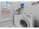 Laundry room area with a white washer, dryer and storage shelves at 207 Cole Ne St, Marietta, GA 30060