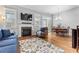 Bright living room featuring hardwood floors, fireplace, and access to the outdoor space at 207 Cole Ne St, Marietta, GA 30060