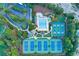 Aerial view features a swimming pool, tennis courts, and landscaped green space at 3198 Highland Forge Trl, Dacula, GA 30019