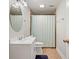 Well-lit bathroom featuring a vanity, toilet, and shower with tiled walls and a blue curtain at 3198 Highland Forge Trl, Dacula, GA 30019