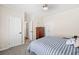 Comfortable bedroom featuring a striped comforter, neutral walls, and ceiling fan at 3198 Highland Forge Trl, Dacula, GA 30019