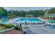 Beautiful community pool with lounge chairs, umbrellas, and a covered seating area at 3198 Highland Forge Trl, Dacula, GA 30019