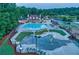 Aerial view features a large community pool, splash pad, and play area with ample seating at 3198 Highland Forge Trl, Dacula, GA 30019