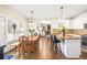 Kitchen flows to dining area with a table set by a bright window and stylish decor at 3198 Highland Forge Trl, Dacula, GA 30019