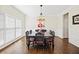 Formal dining room with chandelier, decorative molding, and large windows, perfect for entertaining at 3198 Highland Forge Trl, Dacula, GA 30019