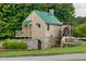 Charming exterior of the historical Hamilton Mill landmark with water wheel at 3198 Highland Forge Trl, Dacula, GA 30019