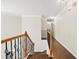 Hallway featuring hardwood floors, wrought iron spindles, and crown molding at 3198 Highland Forge Trl, Dacula, GA 30019