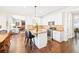 Well-lit kitchen and breakfast nook featuring an island with seating and granite counters at 3198 Highland Forge Trl, Dacula, GA 30019