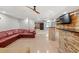 Spacious living room features tiled flooring and stacked stone breakfast bar at 3198 Highland Forge Trl, Dacula, GA 30019