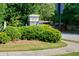 A stone sign marks the entrance to the 'Fairway Bend' community, surrounded by lush greenery and manicured lawns at 3198 Highland Forge Trl, Dacula, GA 30019