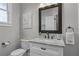 This half bathroom includes a marble vanity and modern fixtures and playful decor at 3433 Pinemont Dr, Douglasville, GA 30135