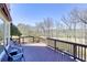 Inviting outdoor deck with wooden furniture, a red awning, and views of the trees and outdoor space at 3433 Pinemont Dr, Douglasville, GA 30135