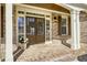 Close-up view of the home's entrance with a brick porch, double doors, and decorative sidelights at 3433 Pinemont Dr, Douglasville, GA 30135