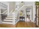 Inviting foyer featuring a staircase with white railings, hardwood floors, and elegant decor at 3433 Pinemont Dr, Douglasville, GA 30135