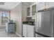 A kitchen area with stainless steel refrigerator, white cabinets, and a small microwave at 3433 Pinemont Dr, Douglasville, GA 30135