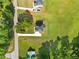 A bird's eye view of a home on an expansive green lot, complemented by verdant trees and a peaceful street at 1300 Snapping Shoals Rd, Mcdonough, GA 30252