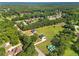 Aerial view showcasing a home set on a sprawling green lot surrounded by lush trees in a quiet neighborhood at 1300 Snapping Shoals Rd, Mcdonough, GA 30252