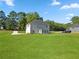 Exterior view showcasing a two-story home with a spacious, well-maintained backyard at 1300 Snapping Shoals Rd, Mcdonough, GA 30252