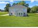 Exterior view showcasing a two-story home with a spacious, well-maintained backyard at 1300 Snapping Shoals Rd, Mcdonough, GA 30252