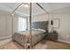 Bedroom featuring a stylish bed with a gray headboard and a patterned gray and white comforter at 1300 Snapping Shoals Rd, Mcdonough, GA 30252