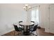 Bright dining area featuring a round marble table with black chairs and a chandelier above at 1300 Snapping Shoals Rd, Mcdonough, GA 30252