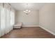 Bright dining room with hardwood floors, large windows, and a stylish chandelier at 1300 Snapping Shoals Rd, Mcdonough, GA 30252