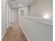 Second floor hallway with carpet, white wainscotting, and neutral walls at 1300 Snapping Shoals Rd, Mcdonough, GA 30252