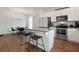 Modern kitchen with white cabinetry, stainless steel appliances, and a granite-topped island with barstool seating at 1300 Snapping Shoals Rd, Mcdonough, GA 30252