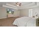 Comfortable main bedroom featuring a TV, walk-in closet, carpet, and tray ceiling at 1300 Snapping Shoals Rd, Mcdonough, GA 30252