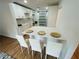 Stylish kitchen bar with white cabinets, quartz countertops, and modern bar stool seating at 1766 Venetian Sw Dr, Atlanta, GA 30311