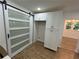 Pantry featuring white cabinets, a modern sliding door, and ample storage space at 1766 Venetian Sw Dr, Atlanta, GA 30311