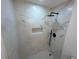 Modern shower featuring elegant marble tiling, built-in niche, and rainfall shower head at 1766 Venetian Sw Dr, Atlanta, GA 30311