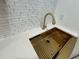 Close-up of a modern sink with gold faucet and subway tile backsplash at 1766 Venetian Sw Dr, Atlanta, GA 30311