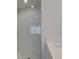 Well-lit bathroom featuring white subway tile, clear glass shower doors, and modern fixtures at 3336 Cranston Ln, Kennesaw, GA 30144