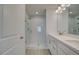 Modern bathroom showcasing double sinks, white countertops, and a glass-enclosed shower with white subway tiles at 3336 Cranston Ln, Kennesaw, GA 30144