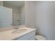 Bathroom with single sink vanity, white cabinets, a large mirror, and a tub/shower combo at 3336 Cranston Ln, Kennesaw, GA 30144