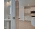 Half bath with pedestal sink leads to a kitchen with white cabinetry and stainless steel appliances at 3336 Cranston Ln, Kennesaw, GA 30144