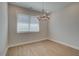 Bright dining room featuring contemporary chandelier lighting and natural light from a window with wood-look flooring at 3336 Cranston Ln, Kennesaw, GA 30144