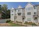 Charming townhome showcasing a modern exterior with gray siding and brick accents, complemented by a well-manicured lawn at 3336 Cranston Ln, Kennesaw, GA 30144