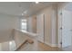 Upstairs hallway with open closet, and neutral walls and carpeting, leading to other rooms at 3336 Cranston Ln, Kennesaw, GA 30144