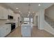 Bright kitchen featuring white cabinets, stainless steel appliances, and a central island with pendant lighting at 3336 Cranston Ln, Kennesaw, GA 30144