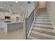 Bright, open-concept kitchen with stainless steel appliances and a large center island adjacent to staircase at 3336 Cranston Ln, Kennesaw, GA 30144