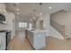 Bright kitchen featuring white cabinets, stainless steel appliances, and a central island with pendant lighting at 3336 Cranston Ln, Kennesaw, GA 30144