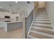 Open concept kitchen with white cabinets, stainless appliances, and an island with a staircase at 3336 Cranston Ln, Kennesaw, GA 30144