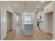 Bright kitchen featuring white cabinets, stainless steel appliances, and a central island with pendant lighting at 3336 Cranston Ln, Kennesaw, GA 30144