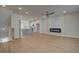 Open-concept living room featuring hardwood floors, a ceiling fan, and a modern fireplace at 3336 Cranston Ln, Kennesaw, GA 30144