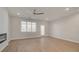 Bright living room featuring hardwood floors, a ceiling fan, and modern fireplace at 3336 Cranston Ln, Kennesaw, GA 30144