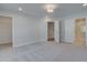 Spacious main bedroom showcasing multiple doorways, plush carpeting, and neutral tones throughout the home at 3336 Cranston Ln, Kennesaw, GA 30144