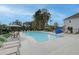 Large community pool area includes multiple lounge chairs, umbrellas, and natural shade at 3336 Cranston Ln, Kennesaw, GA 30144